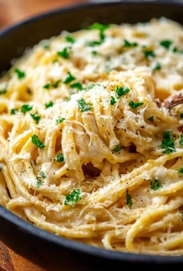 Delicious garlic parmesan spaghetti garnished with parsley and cheese