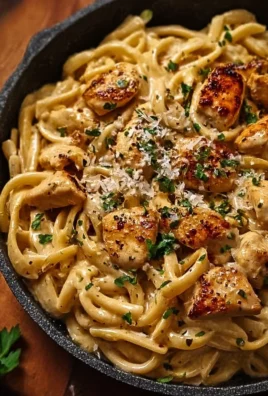 Creamy Cajun chicken pasta served in a bowl with herbs on top