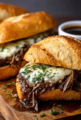 Crockpot French dip sandwiches served with au jus for dipping