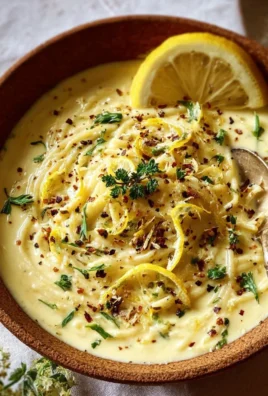Creamy lemon garlic dish served in a bowl, garnished with herbs.
