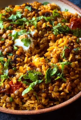 A colorful bowl of Mediterranean Lentils and Rice garnished with herbs.