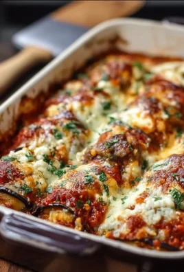 Fluffy eggplant rollatini bake topped with marinara and melted cheese.