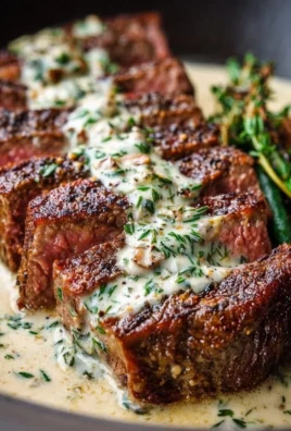 Garlic butter steak served with creamy Parmesan sauce on a plate