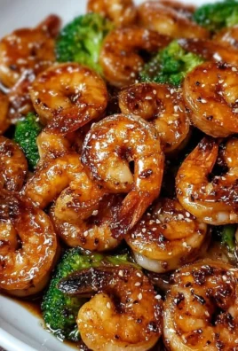 High-protein honey garlic shrimp served on a plate with vegetables.