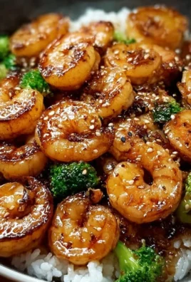 Delicious high-protein honey garlic shrimp served on a plate with garnish.