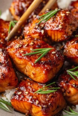 Delicious Honey Garlic Salmon Bites served on a plate garnished with herbs