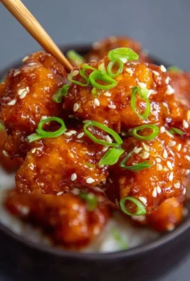 Delicious Honey Sesame Chicken served with sesame seeds and vegetables