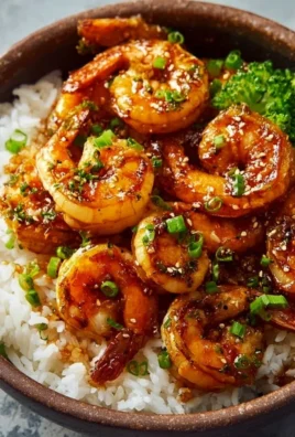 Delicious honey garlic shrimp bowl garnished with fresh vegetables and rice
