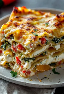 Loaded veggie white lasagna featuring layers of fresh vegetables and creamy sauce
