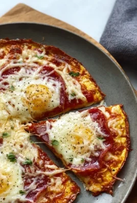 Delicious Pizza Eggs served on a plate with toppings and cheese melting.
