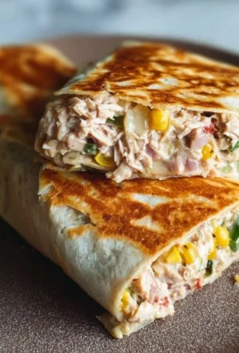 Tuna melt wrap with creamy tuna salad and melted cheese in a tortilla