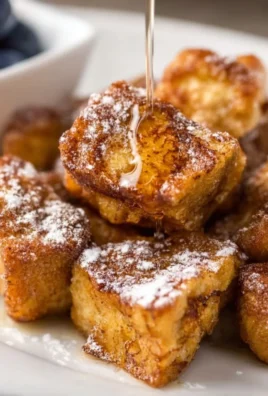 Delicious air fryer French toast bites served with syrup and berries.