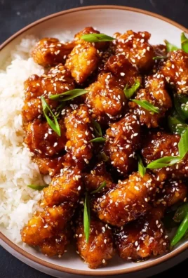 Plate of Asian High Protein Sesame Chicken garnished with sesame seeds