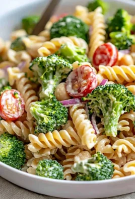 Delicious broccoli pasta salad served in a bowl with fresh ingredients