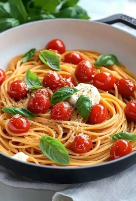 Delicious bowl of cherry tomato pasta with basil and parmesan
