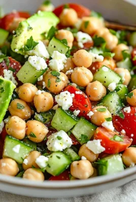 Colorful chickpea salad with fresh vegetables and herbs in a bowl
