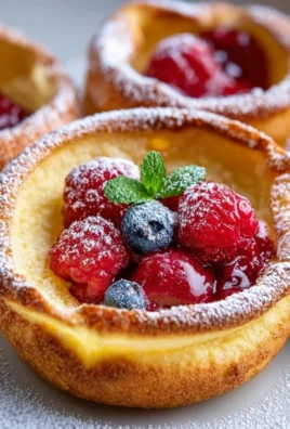 Delicious mini Dutch baby pancakes with fresh fruit and powdered sugar