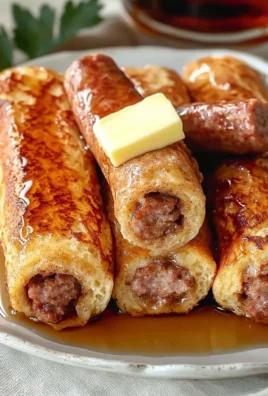 Delicious French Toast Roll-Ups filled with cream cheese and topped with syrup