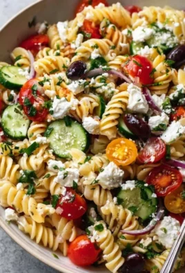Colorful Greek Pasta Salad with vegetables, olives, and feta cheese