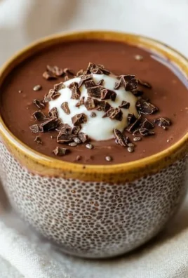Bowl of high protein chocolate chia seed pudding topped with fresh berries