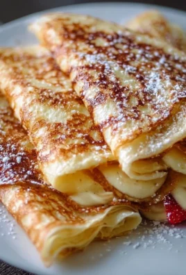 Delicious high-protein cottage cheese crepes topped with fresh fruits and syrup
