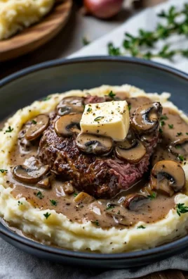 Juicy meat dish with creamy sauce and mushrooms served on a plate
