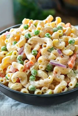 Delicious homemade Macaroni Salad served in a bowl with colorful vegetables