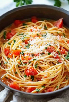 Delicious One Pot Pasta dish served in a bowl with fresh vegetables and herbs.