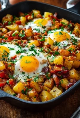 Savory breakfast hash with potatoes, eggs, and veggies served in a skillet