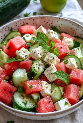 Bright and colorful watermelon cucumber feta salad served in a bowl.