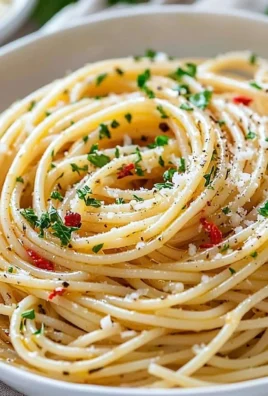 Plate of spaghetti with garlic and olive oil garnished with parsley