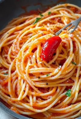 Spaghetti served with spicy tomato and pepper sauce garnished with fresh herbs