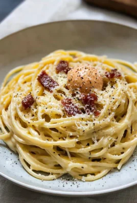 Creamy spaghetti carbonara beautifully plated with parmesan and parsley.