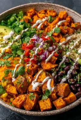Delicious vegan sweet potato burrito bowl topped with fresh veggies and spices