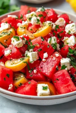 Delicious watermelon feta salad served in a bowl with fresh mint leaves.