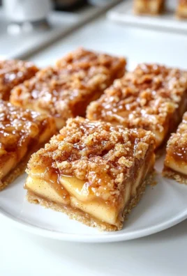 Delicious apple pie bars topped with crumble and served on a plate