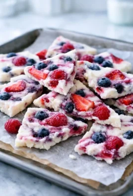 Delicious berry yogurt bark topped with fresh fruits and nuts