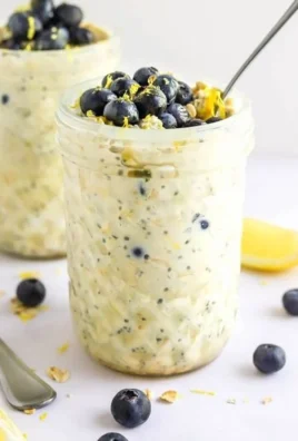 A bowl of Blueberry Lemon Overnight Oats with fresh blueberries and lemon zest