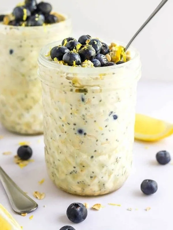 A bowl of Blueberry Lemon Overnight Oats with fresh blueberries and lemon zest
