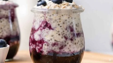 Bowl of blueberry overnight oats topped with fresh blueberries and almonds