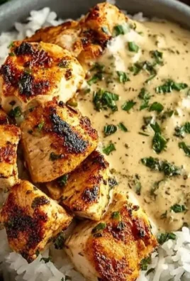 Creamy garlic chicken bowls served in a meal prep container with herbs