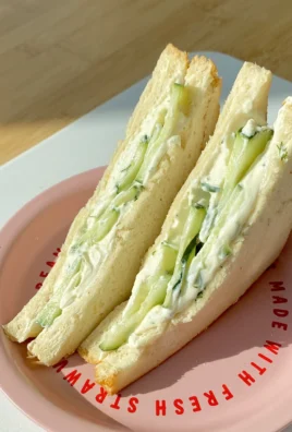 Cucumber Cream Sandwich with fresh herbs on a plate