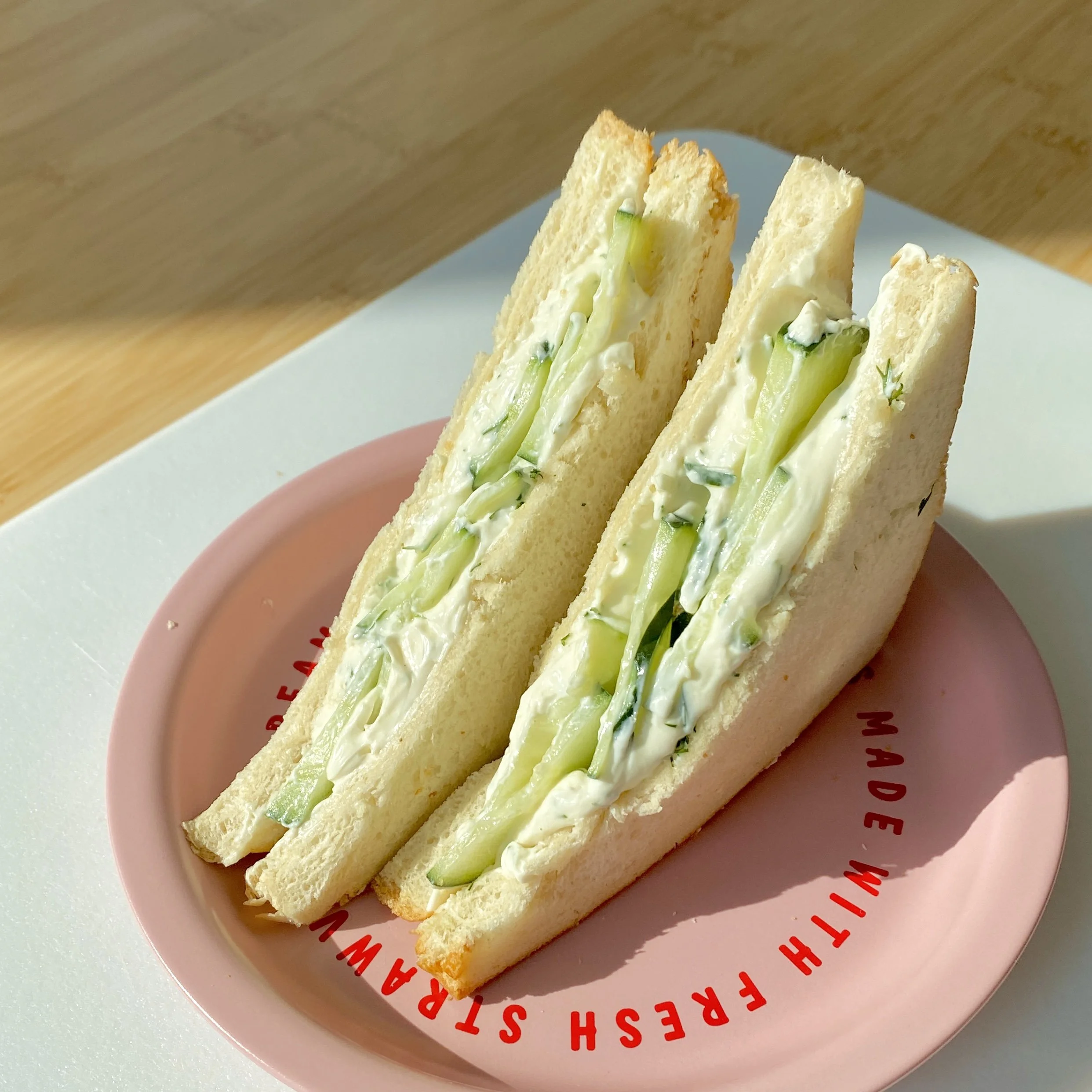 Cucumber Cream Sandwich with fresh herbs on a plate