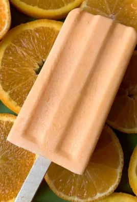Homemade orange creamsicles ready to be enjoyed on a sunny day