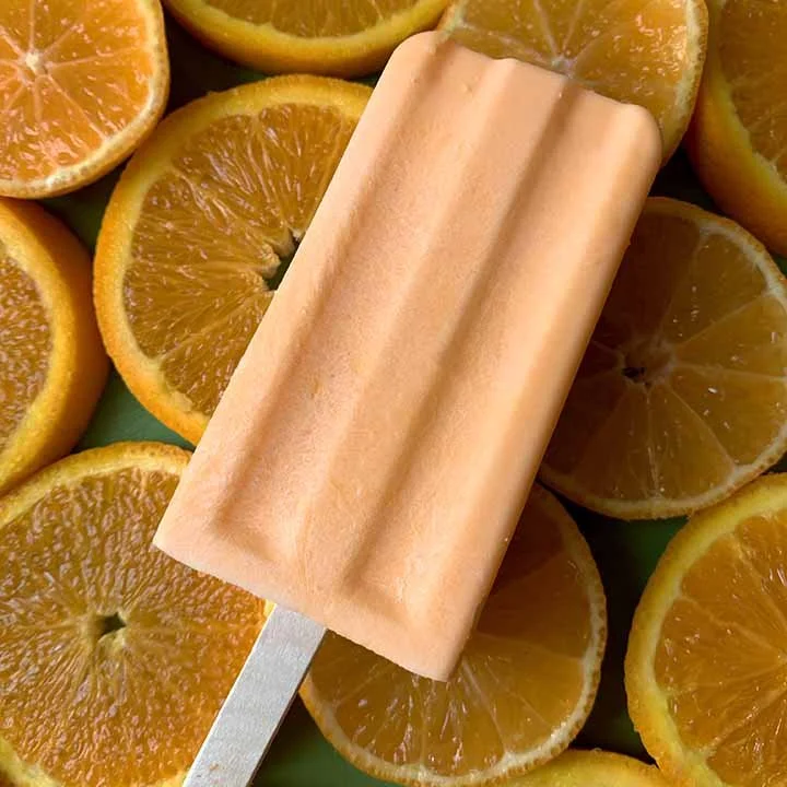 Homemade orange creamsicles ready to be enjoyed on a sunny day