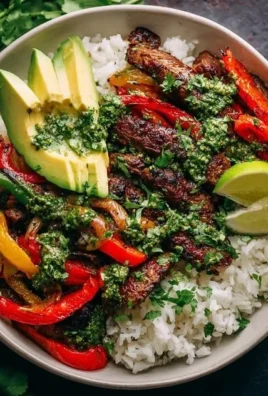 Delicious smoky steak bowl with fresh veggies and rice in a vibrant bowl