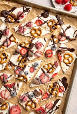 Delicious homemade frozen yogurt bark topped with fruits and nuts.