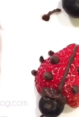 Colorful fruit and chocolate ladybugs on a plate for a fun dessert