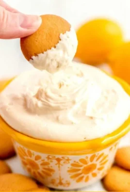 Lemon Cream Pie Cheesecake Dip in a bowl with graham cracker crumbs