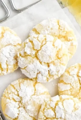 Freshly baked Lemon Crinkle Cookies dusted with powdered sugar